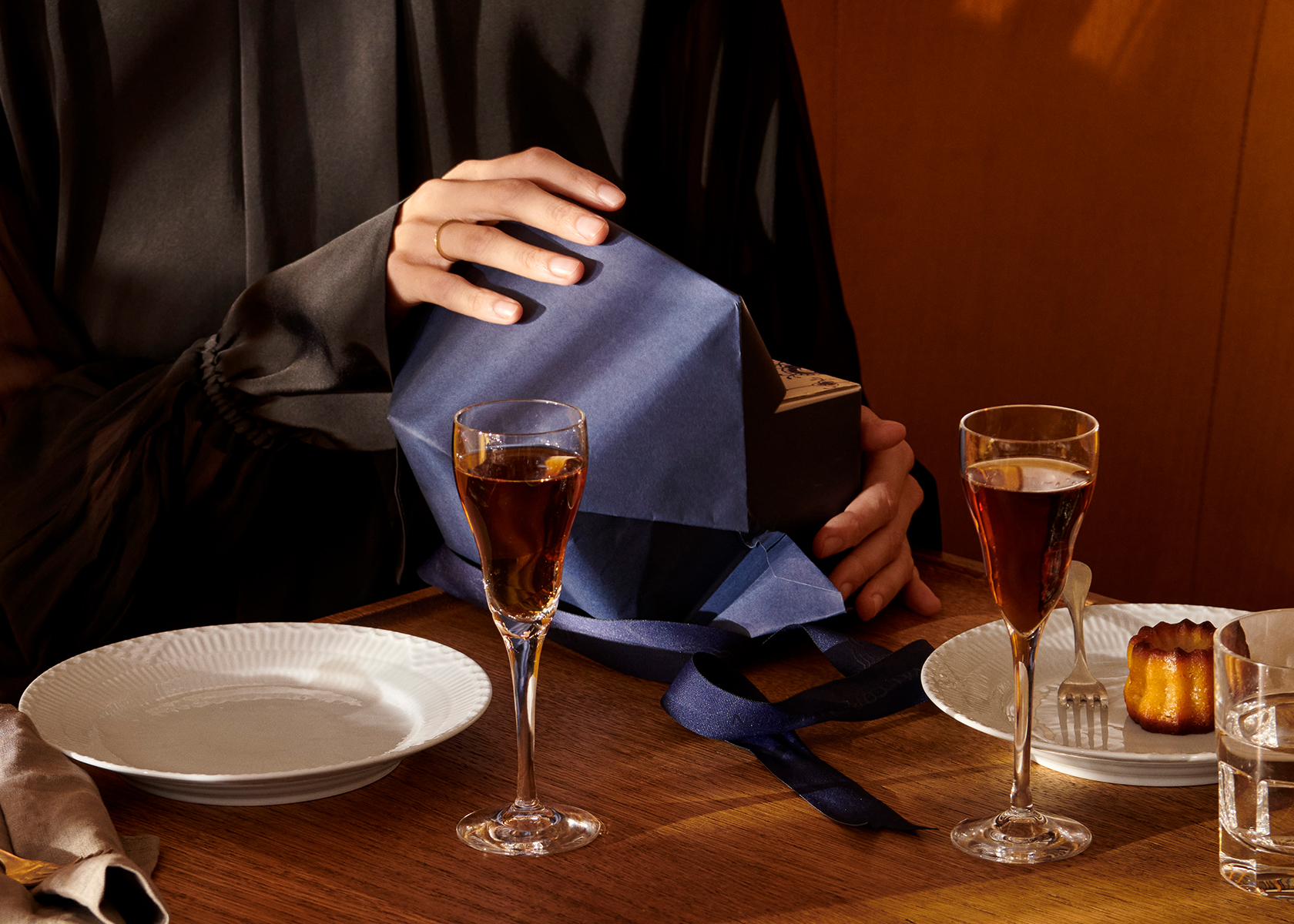 A mother unwrapping her gifts on Mother's Day during an intimate lunch
